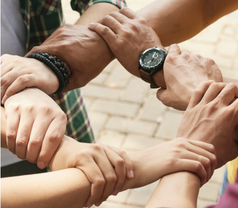 people holding each other's wrists to form a circle